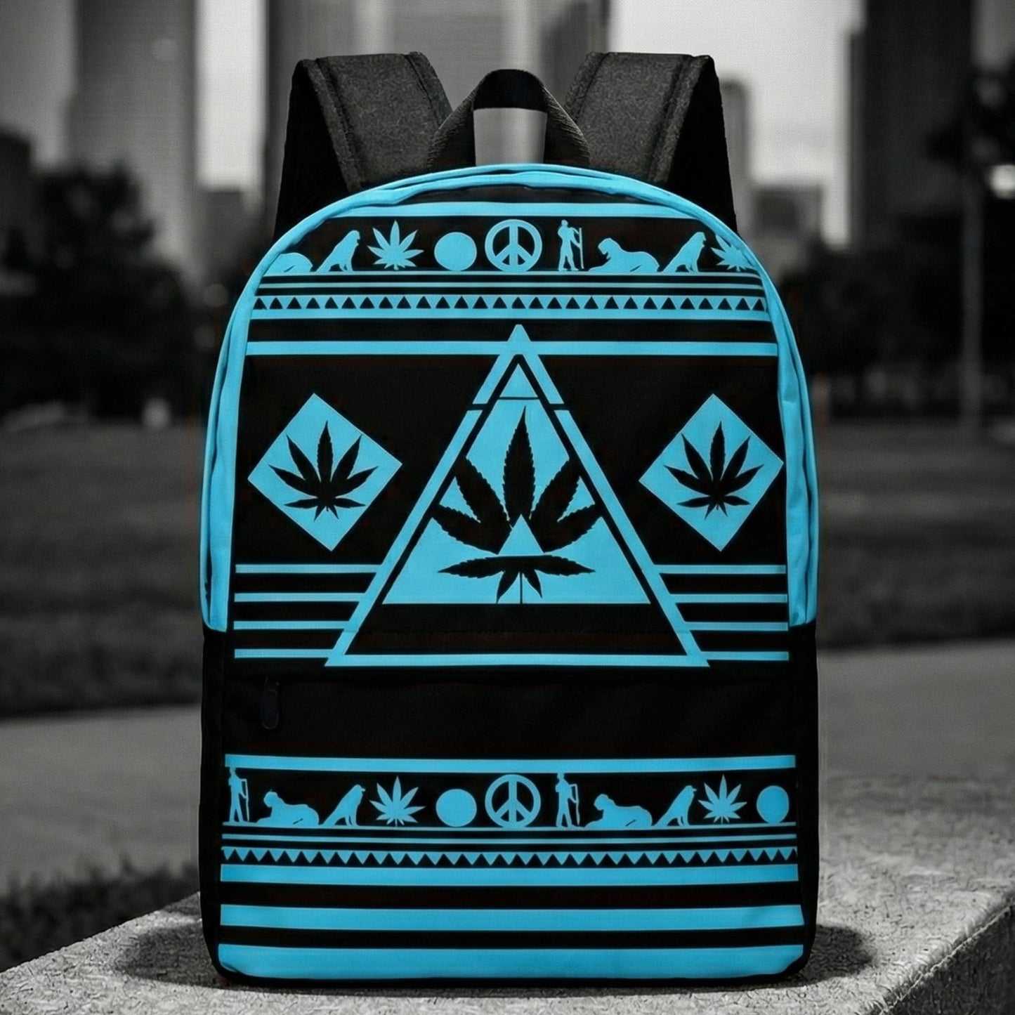 Wide shot of the NGU Gamma Blue backpack resting on a concrete surface in an urban park setting with a monochromatic city skyline background.