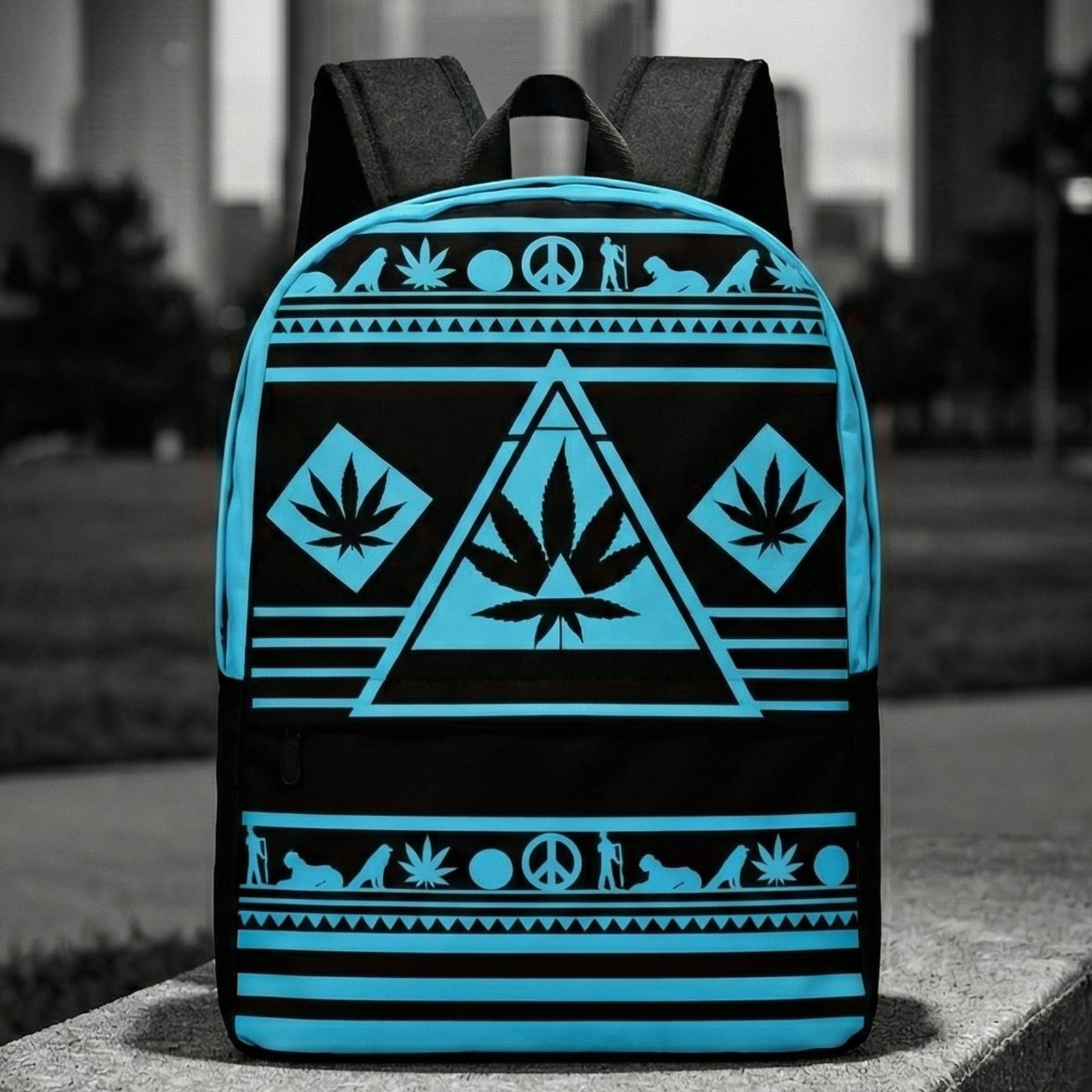 Wide shot of the NGU Gamma Blue backpack resting on a concrete surface in an urban park setting with a monochromatic city skyline background.