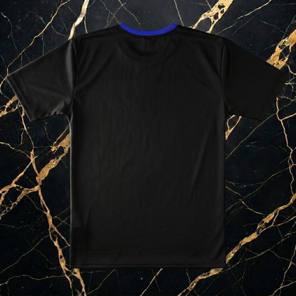 Flat lay product display of NGU Vanguard print-all-over technical polyester shirt paired with purple distressed stacked jeans and Deep Royal Blue Foamposites on a clean white marble surface.