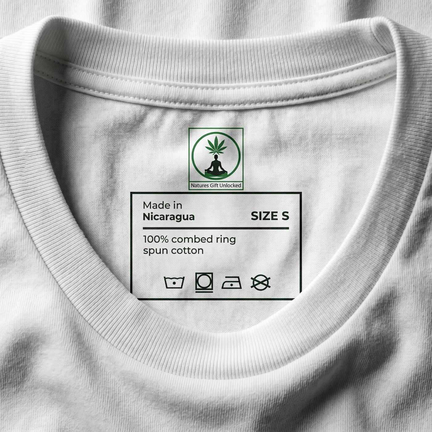 Macro shot of NGU interior neck tag on a white cotton shirt showing size small and premium manufacturing details