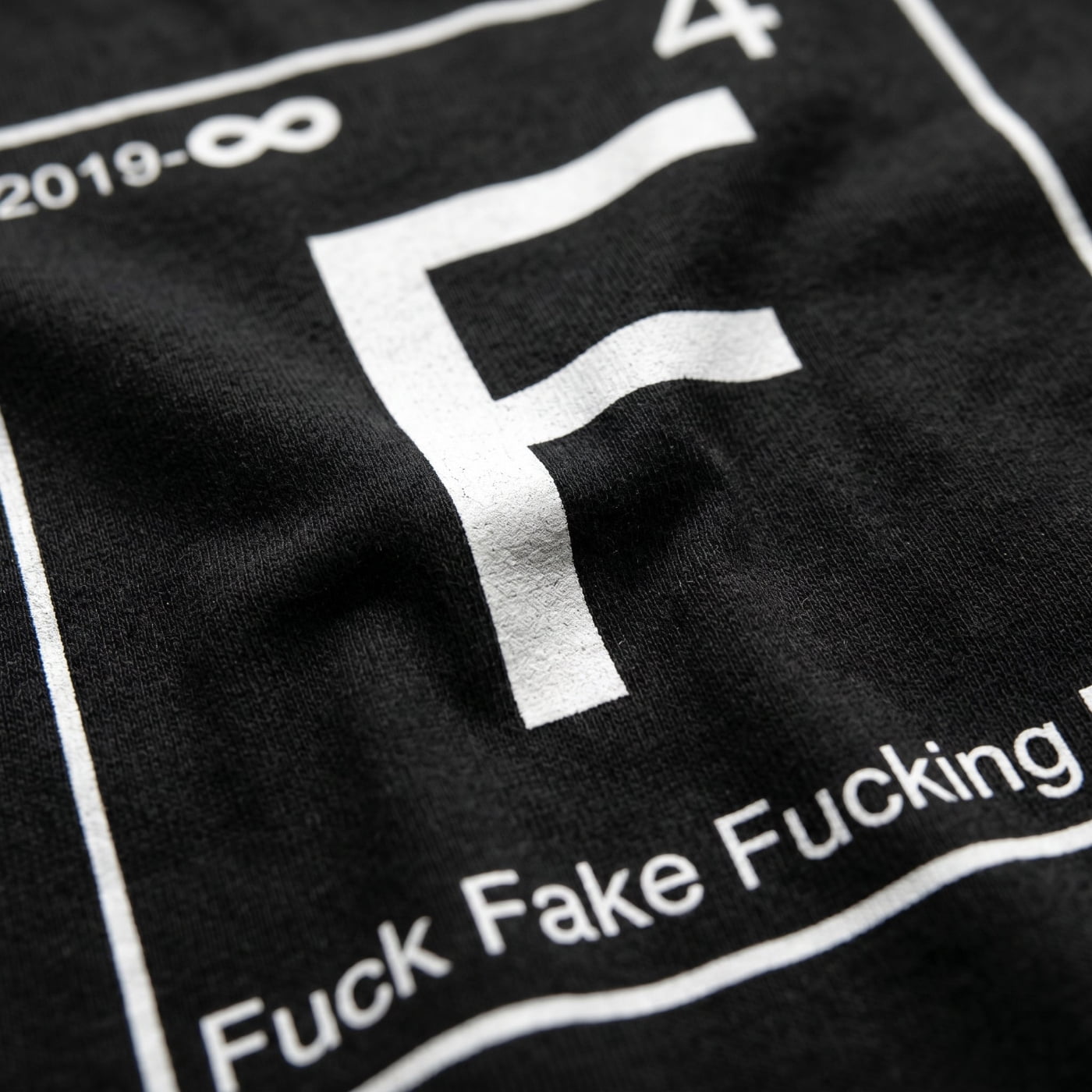 wearing size XL NGU "Fuck Fake Fucking Friends" 400gsm tee in a high-end bedroom mirror reflection lifestyle shot.