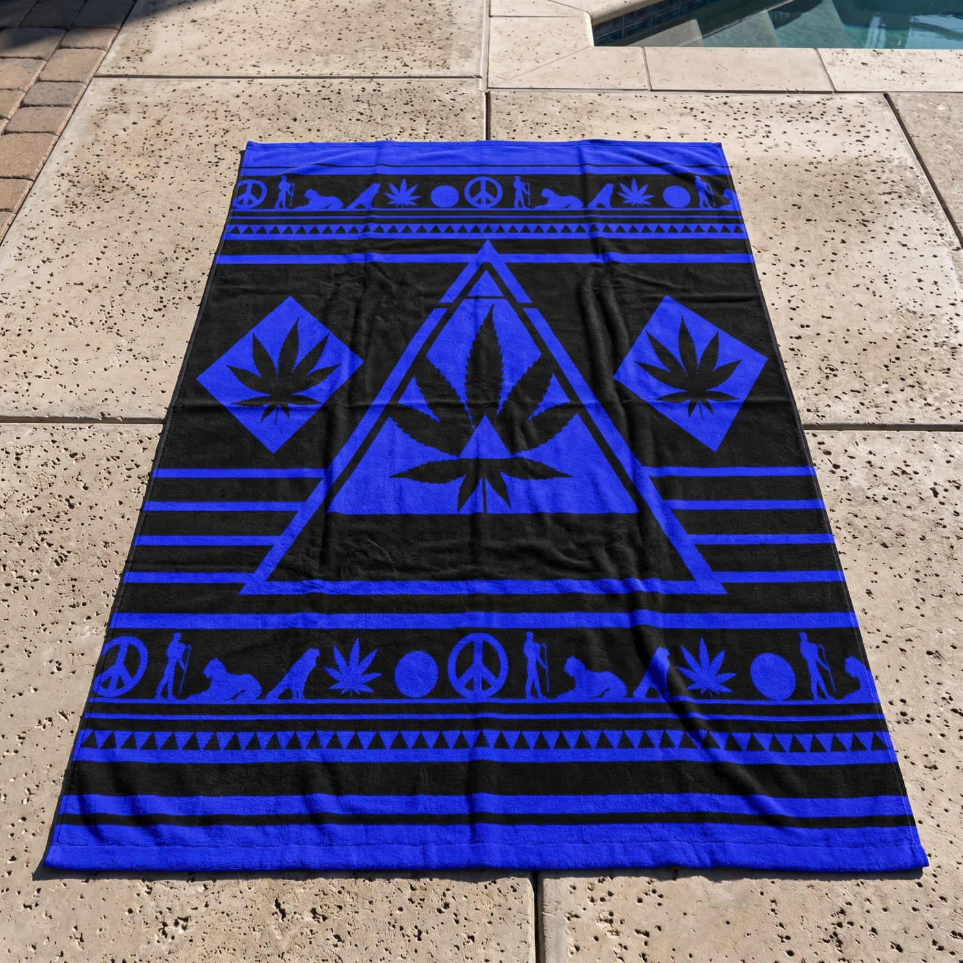 Full top-down perspective of the oversized 36x72 NGU Architect Towel in Black and Electric Blue. The towel is spread across a textured concrete pool deck, showcasing the vibrant blue geometric manifesto and heavy 360gsm cotton substance with natural fabric folds.