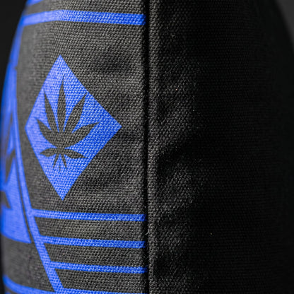 Side-angle detail of the NGU Architect pillow showcasing the thick 275gsm canvas texture and the vector-sharp blue graphic alignment on the matte-black fabric.