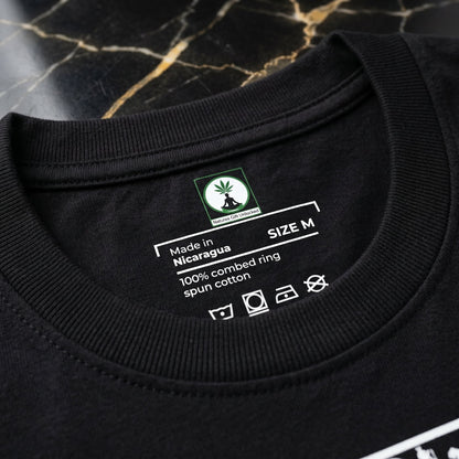 Forensic macro of NGU internal neck branding screen-printed in white ink on 400gsm matte-black cott