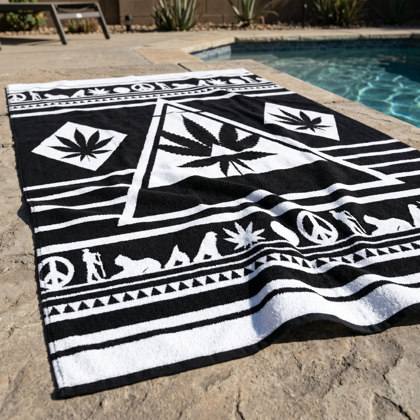 Full view of the Black and White NGU Architect Towel spread across a white bed. The 36x72 oversized scale is demonstrated by the coverage of the mattress. The design features a large central white geometric leaf manifesto with sharp architectural lines on a matte-black cotton base.