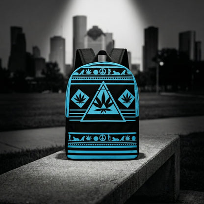 Wide shot of the NGU Gamma Blue backpack resting on a concrete surface in an urban park setting with a monochromatic city skyline background.