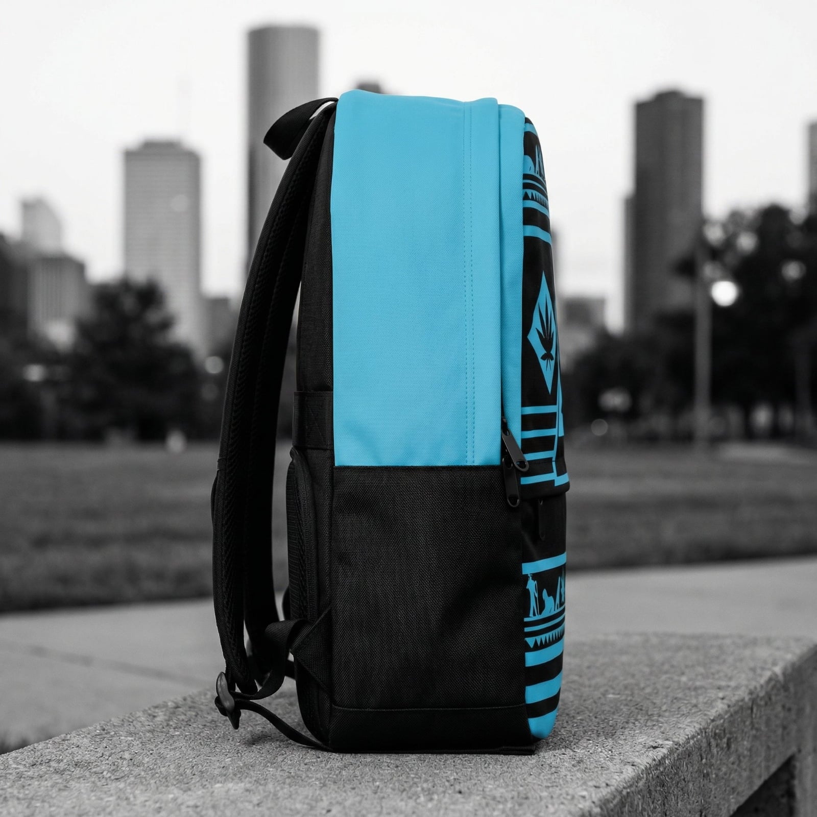 Side view profile of the NGU backpack showing the clean transition between the patterned front face and the solid matte black side panels.