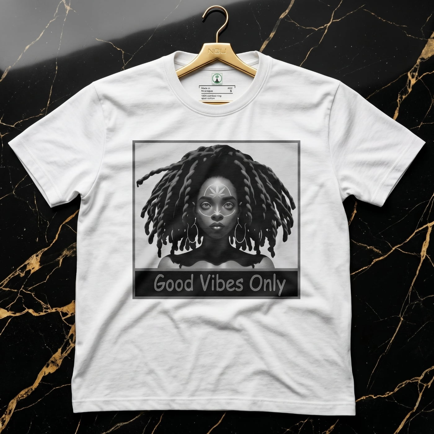 NGU Monochrome Muse white heavyweight graphic t-shirt displayed on a polished 18k gold hanger in a luxury flagship setting