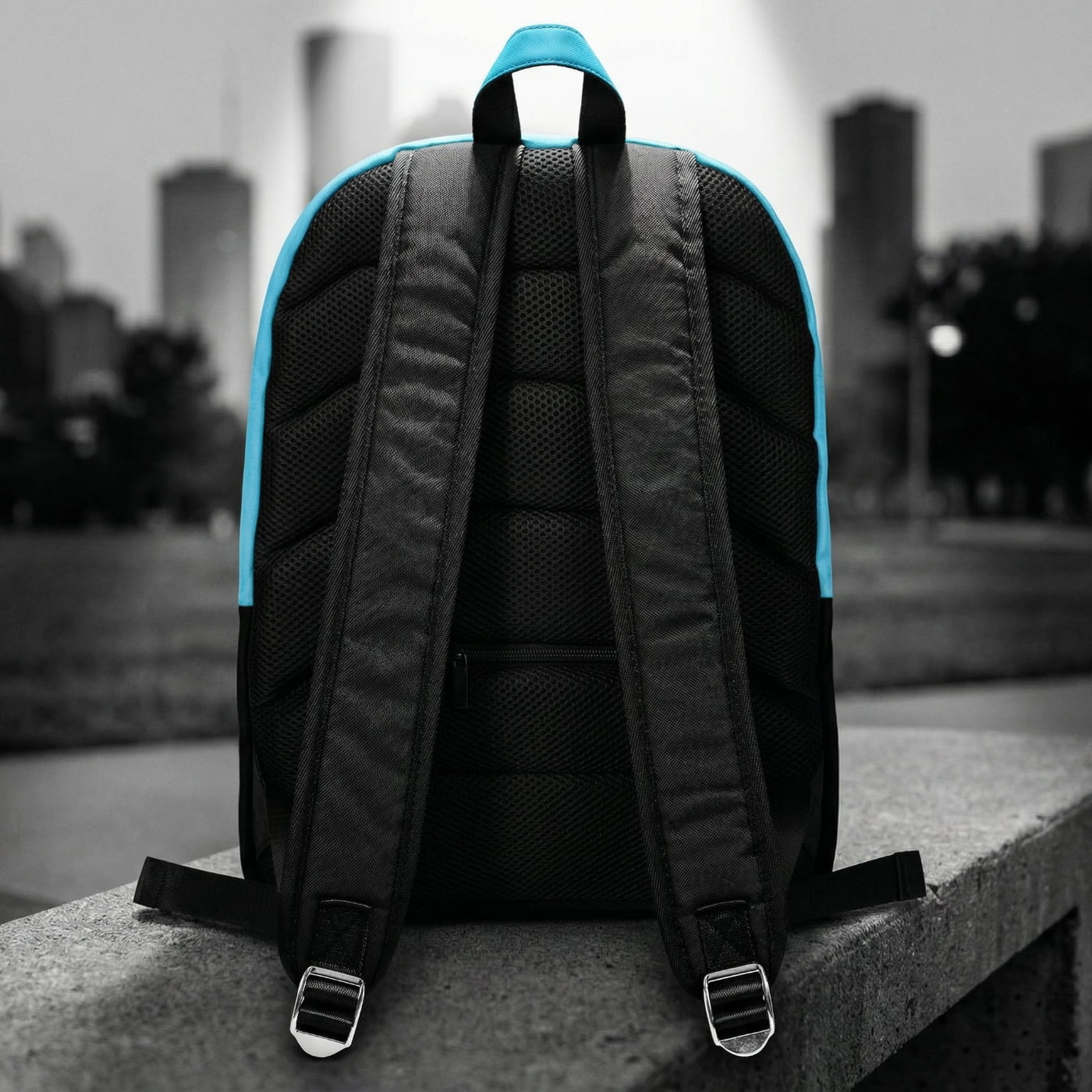Rear view of the backpack showing the heavy-duty padded black mesh shoulder straps and solid matte black back construction.