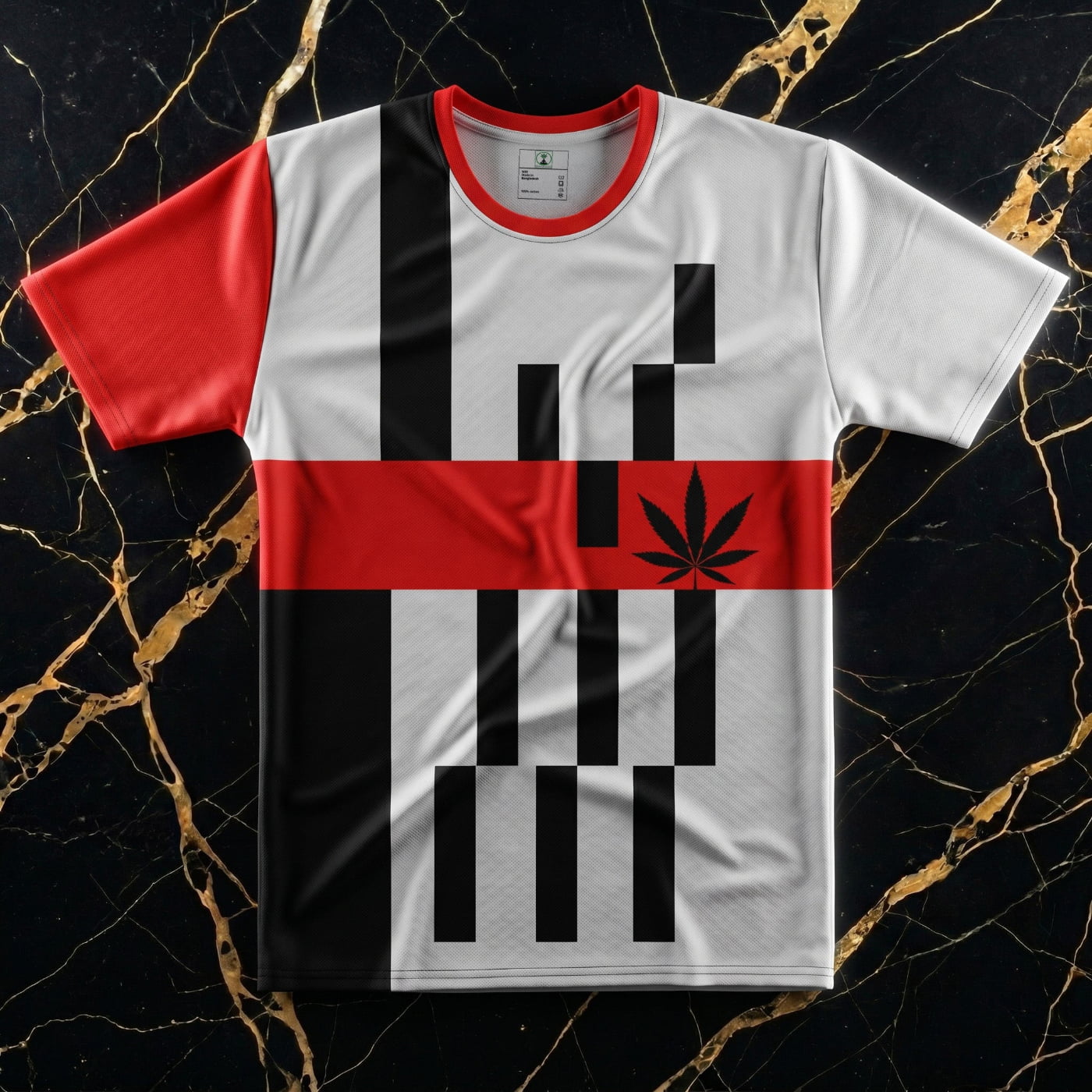 Close-up focus on the NGU Vanguard performance shirt featuring the central cannabis leaf design, red asymmetric sleeve, and precision-flat lay collar.