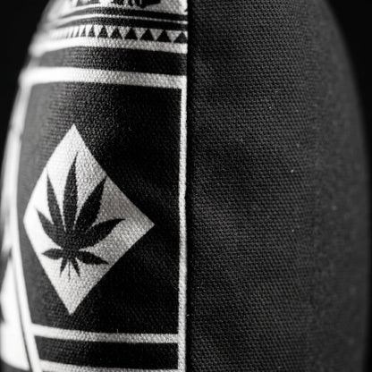 Side-angle detail of the Black and White NGU Architect pillow showcasing the thick 275gsm canvas texture and the vector-sharp white weed leaf alignment on the matte-black fabric.